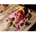 Apple Cinnamon Sachet by Irish Twins Potpourri's sits on a rustic wood surface. Dried bontanicals and cinnamon sticks are scattered about.